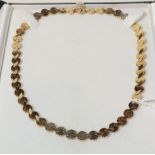 A fancy link necklace, clasp stamped '375', length 41.5cm . Gross weight 27.1 grams.