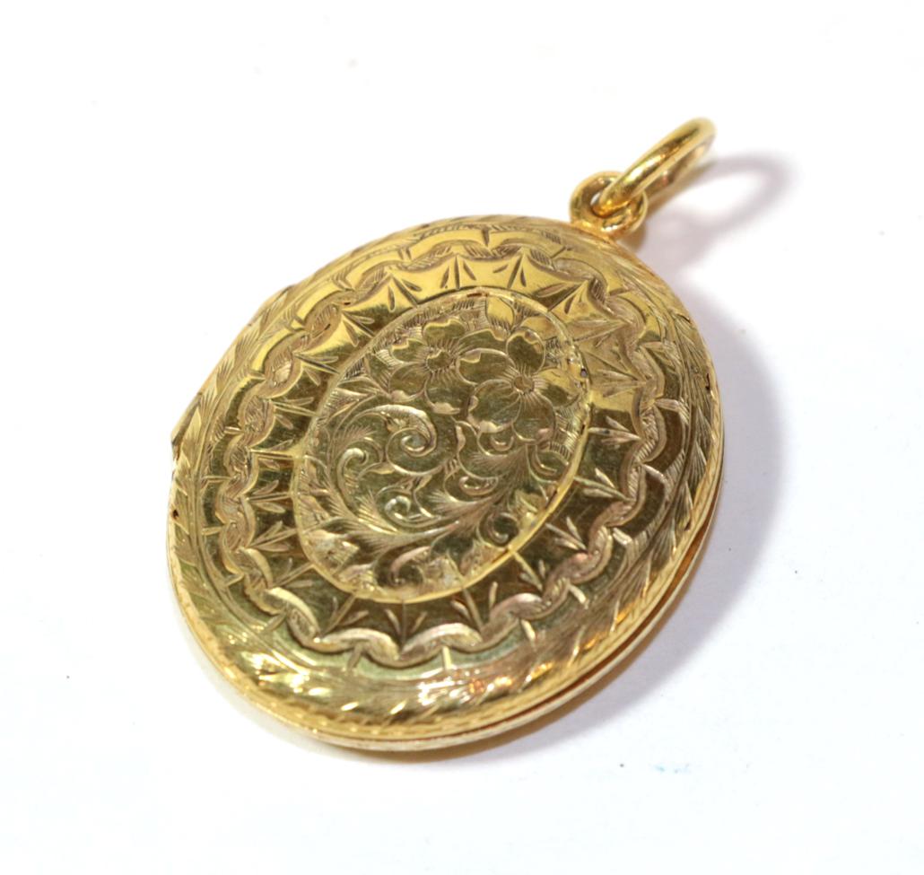 A foliate engraved locket, unmarked, length 4cm. Gross weight 11.3 grams.