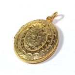 A foliate engraved locket, unmarked, length 4cm. Gross weight 11.3 grams.