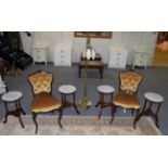 A pair of rosewood framed side chairs upholstered in yellow velvet; five marble top occasional