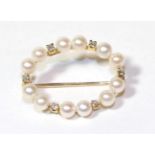 A cultured pearl and diamond hoop brooch, stamped 'CB 750', length 2.6cm . Gross weight 3.2 grams.