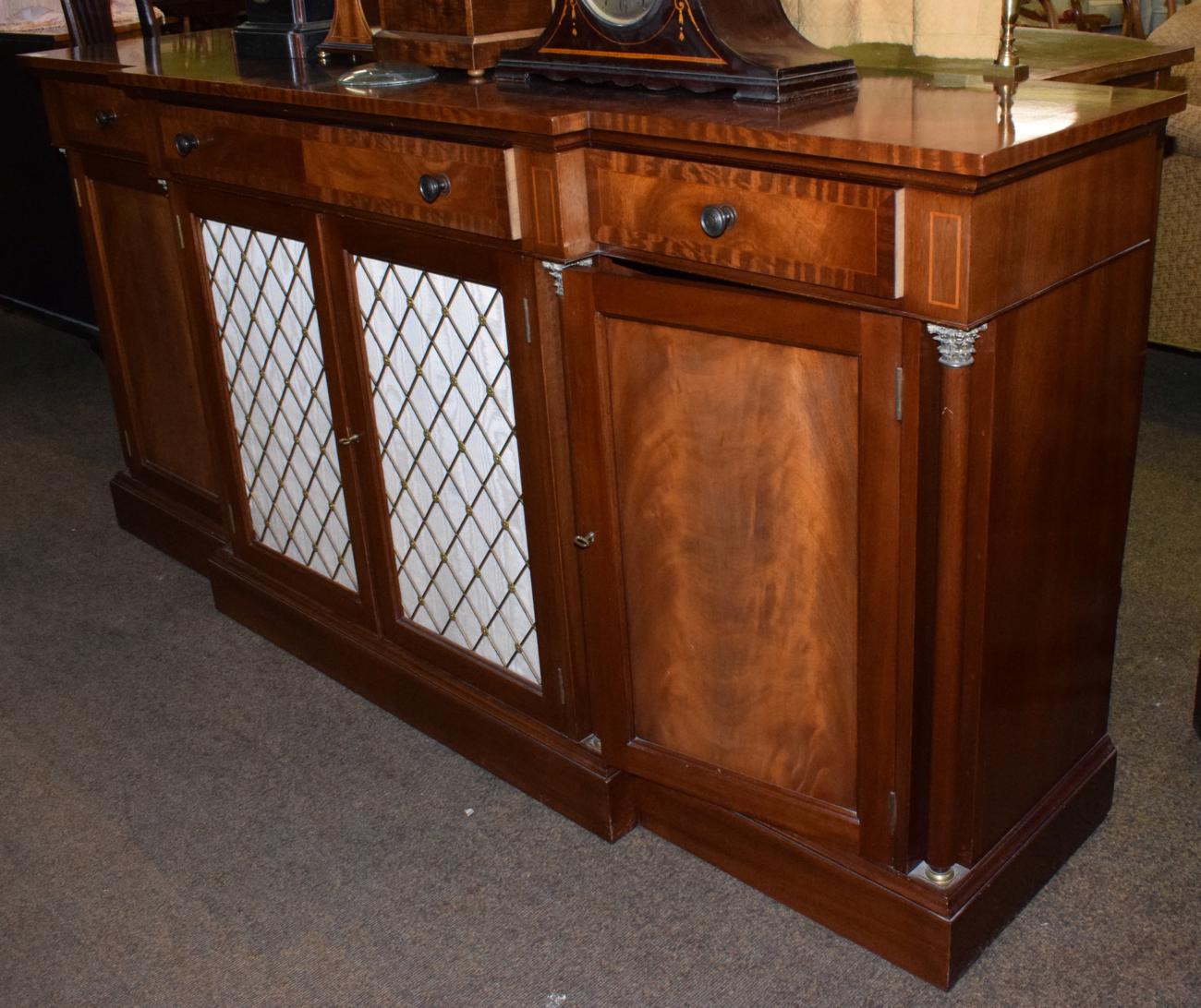 A reproduction mahogany and crossbanded sideboard with metal grille doors, 195cm wide In good