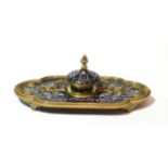 A late 19th century brass and enamelled inkwell of lancet Gothic Revival design, 28cm width In