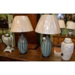 A pair of large green pottery table lamps with silk shades, and two other ceramic lamps (4)