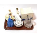 A Waterford cut glass water jug; a Wedgwood powder bowl; three Royal Doulton china figures of ladies