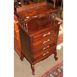 An early 20th century four drawer chest with spindle turned shelf