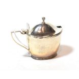 A George III silver mustard-pot, by John Emes, London, 1802, tapering oval and with reeded rims, the