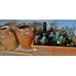 Crate (wooden) of assorted old glass bottles and two stoneware jars