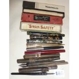 Assorted vintage fountain pens with two empty boxes. Pen makes include Swan Mabie Todd Blackbird,