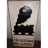 Modern cast iron sign depicting a locomotive with legend under "CROSSING NO GATES"