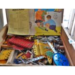 Box of assorted Meccano parts (blue, yellow, red and green)