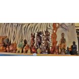 Shelf of assorted Oriental carved wood and metal buddhas and other figures (21 items)