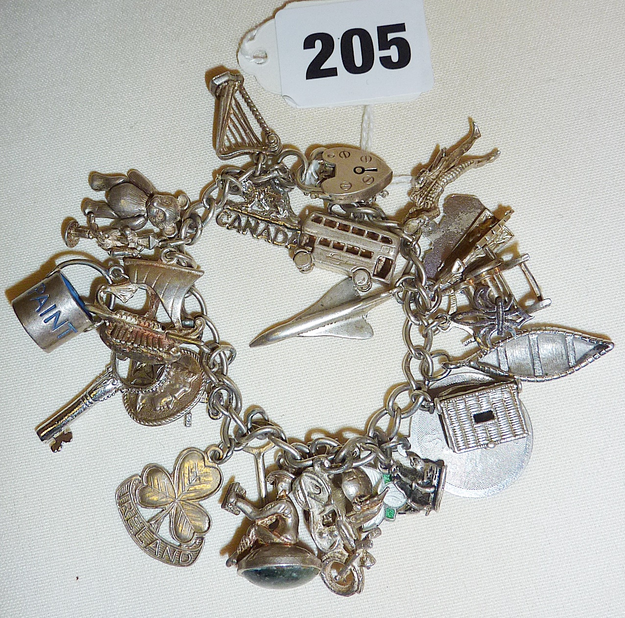 Vintage silver charm bracelet with many charms, some hallmarked, some Continental silver