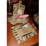 Pierced brass inkstand with glass inkwell and another two inkwells and ornate clock to back