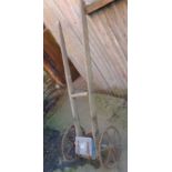 Antique long handled iron and wood seed drill