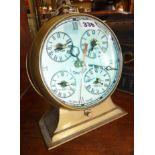 Unusual round brass "World Time" clock having magnifying convex glass cover to dial with five time