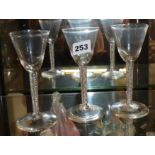 Three opaque twist wine glasses, with round funnel bowls and conical feet