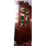 Victorian mahogany bookcase having shaped pediment with glazed doors enclosing adjustable shelves