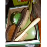 Assorted hairbrushes and enamel topped glass jars