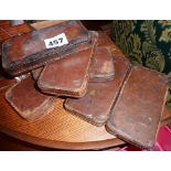 Six Edwardian leather covered weights for use in competitive horse racing or saddlery