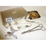 Silver plated cigarette box, with contents, inc. grape scissors, compact, sugar tongs etc.