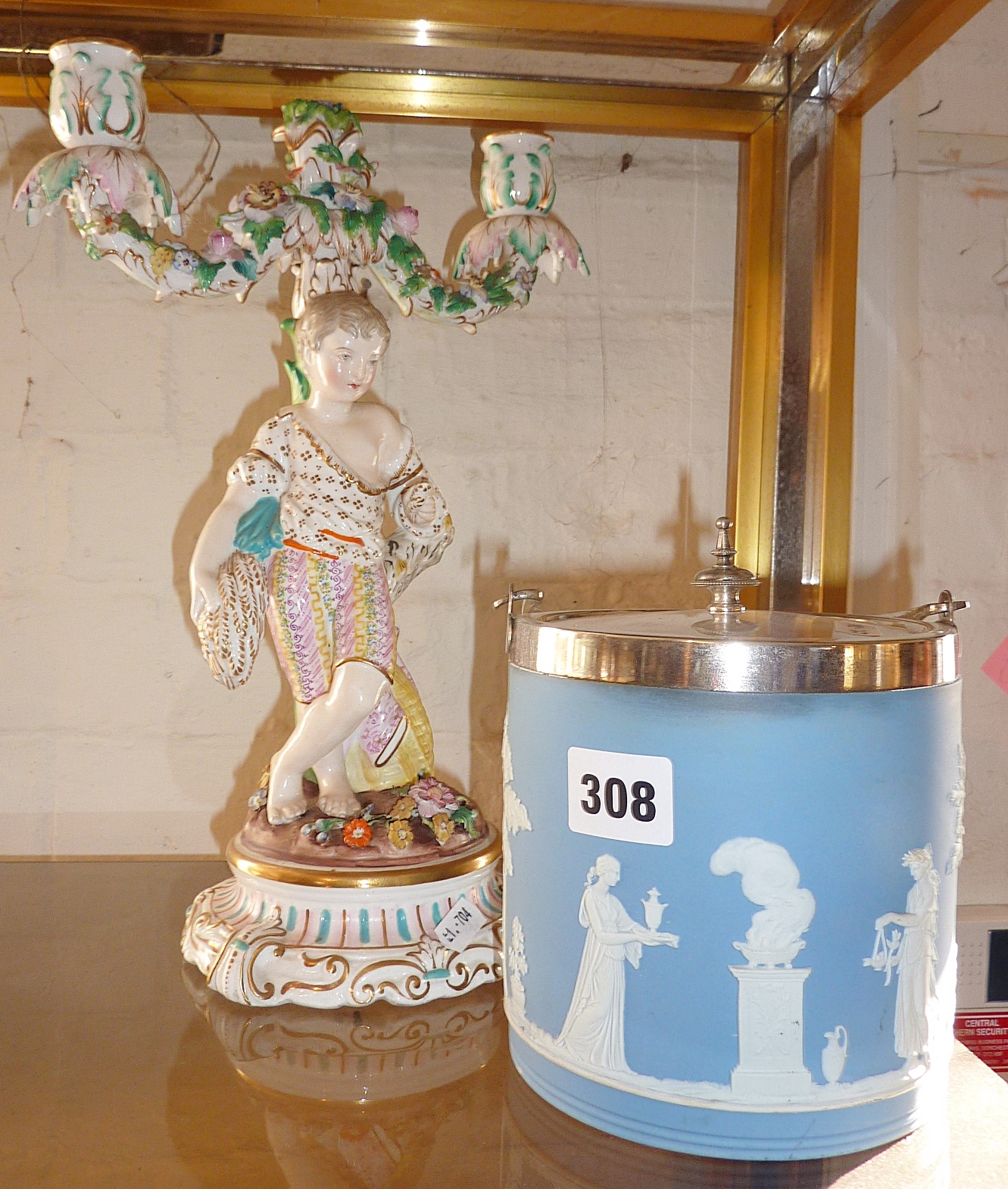 Continental porcelain figural two branch candlestick and a Wedgwood blue Jasperware biscuit barrel