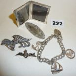 Silver charm bracelet, small silver photograph frame, silver brooches, etc.