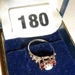 Hallmarked silver ring set with an opal and rubies, size M