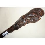 Old carved walking cane with handle carved as a lion and flowers, European
