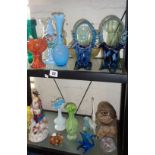 Two shelves inc. coloured glassware, hyacinth vases and Poole Pottery stoneware owl