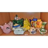 Shelf of novelty china tea pots