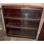 Three section bookcase with sliding glass doors