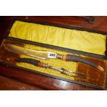 Victorian carving set in velvet and silk lined box having stag horn handles with silver bands, the