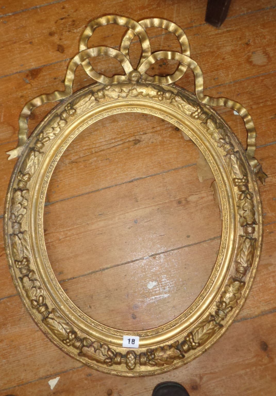 19th c. oval giltwood and gesso frame with entwined ribbon with a convex glass portrait of a lady