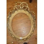 19th c. oval giltwood and gesso frame with entwined ribbon with a convex glass portrait of a lady