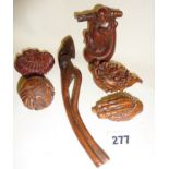 Chinese carved hardwood pendant in the form of a coiled dragon and five other similar items, inc.