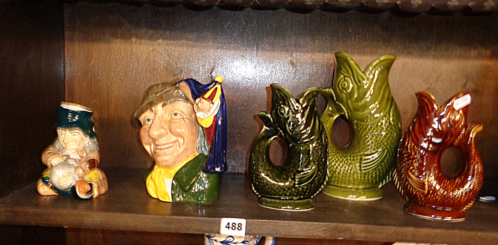 Royal Doulton Punch & Judy Man toby jug, another and three Dartmouth Pottery fish gurgle jugs