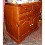 Contemporary small dresser having four drawers above two cupboard doors