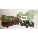 Chinese jade or Peking glass carved horse and lion on wooden bases