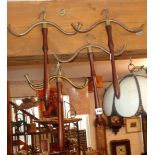 Five 19th c. Campaign style mahogany and brass coat hangers