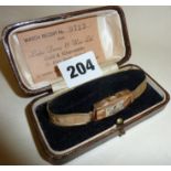 Classic Art Deco 9ct gold watch with rolled gold strap, in original case. Maker "Lyon"