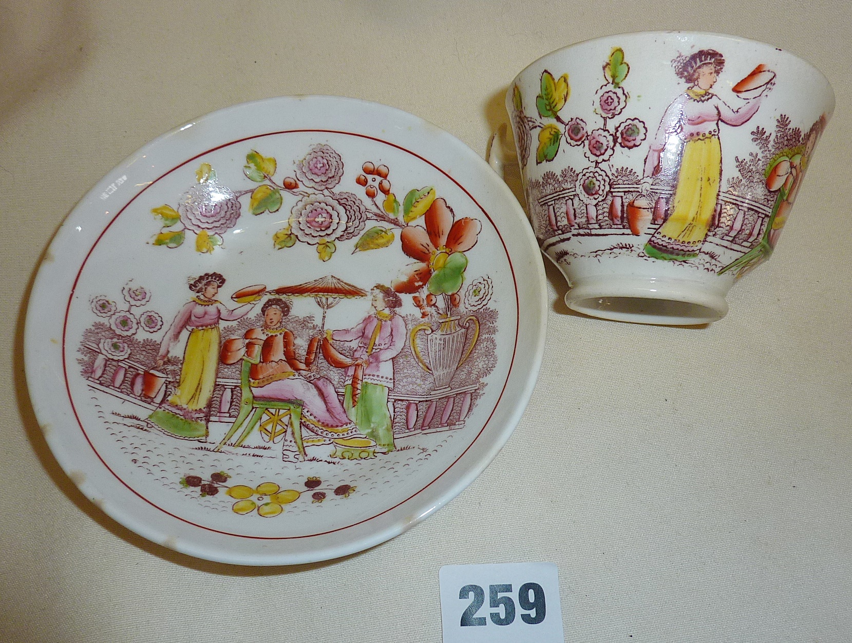 An antique English porcelain cup and saucer (A/F)