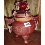 Chinese Sang de Boeuf lidded pot with two handles on tripod feet