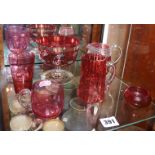 Seven pieces of assorted cranberry glass