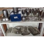 Two shelves of Old Hall stainless steel including toast racks etc, some Robert Welch designs