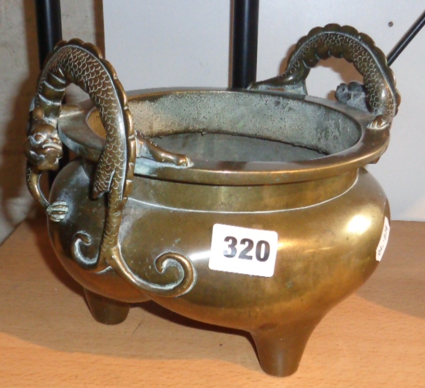 Chinese Qing bronze censer with dragon handles and tripod feet and impressed Xuande character