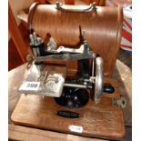 A Federation Baby? toy sewing machine in wood case (very similar to the Singer No 20)