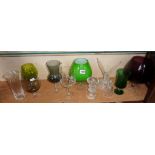 Shelf of assorted coloured glassware