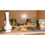 Shelf of assorted frog ornaments