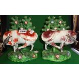 Pair of Staffordshire figures of cows with lifted legs